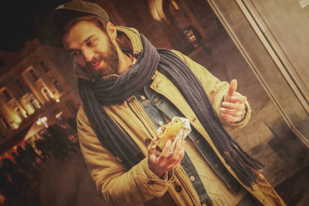 istock Man with burger on the street 876322106