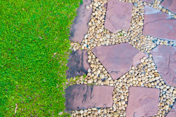 istock Green grass field with stone pathway and small rock decoration. 876322356