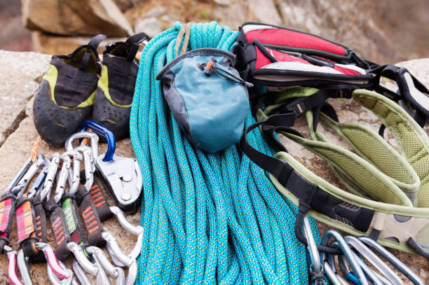 Climbing equipment - bag for magnesia on the ground or carabines and rope on a background. Concept of outdoor sport