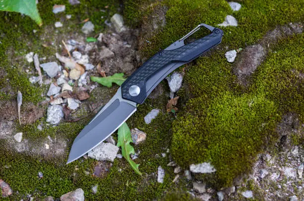Photo of A pocket knife with a black handle and a black blade.