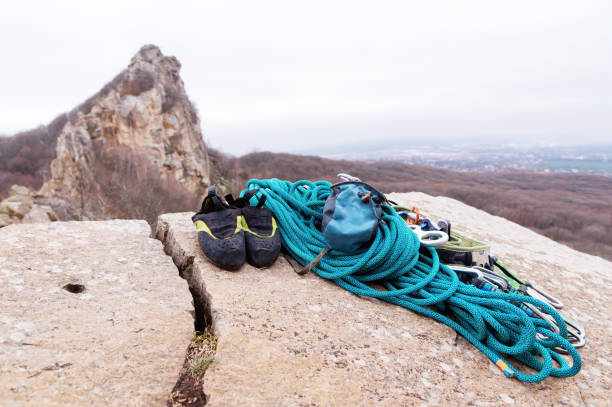 Climbing equipment - bag for magnesia rope and carbines view from the side close-up. A rocks and mountains on background. Concept of outdoor sport