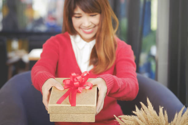 istock Woman holding small red present box in hands. Christmas Concept. 876343652