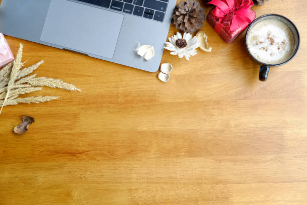 istock Desk with laptop, gift and coffee cup. copy space 876343900