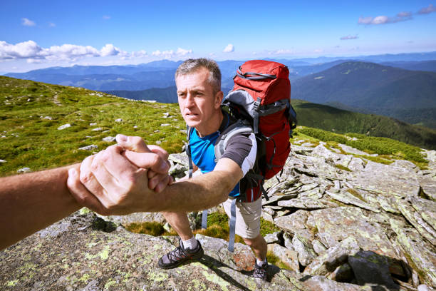 istock Help, support and help in a dangerous situation to hike in the mountains. 876344172