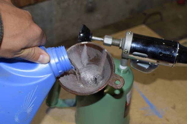istock Pouring gasoline blowtorch through the funnel 876350356