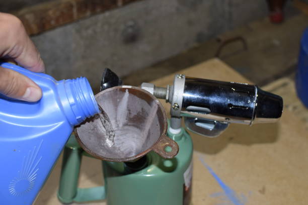 istock Pouring gasoline blowtorch through the funnel 876350366