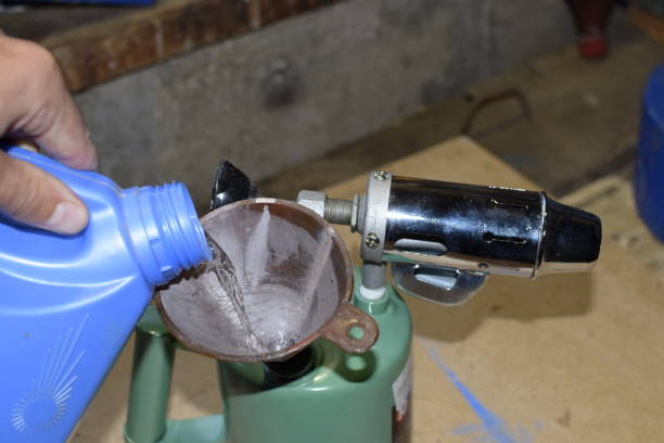 istock Pouring gasoline blowtorch through the funnel 876350376