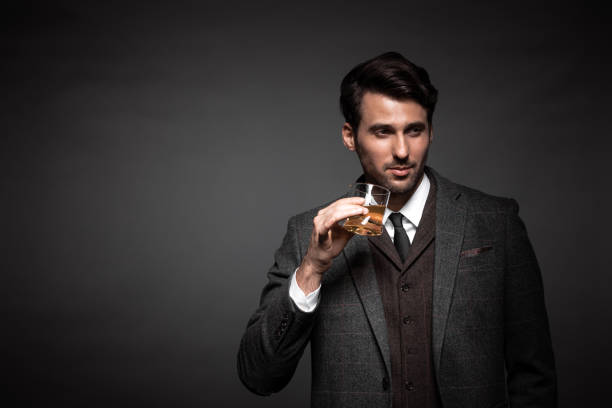 istock Portrait of handsome man drinking whiskey 876378198