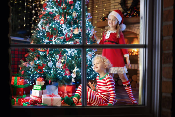 istock Child at Christmas tree. Kids at fireplace on Xmas 876378288