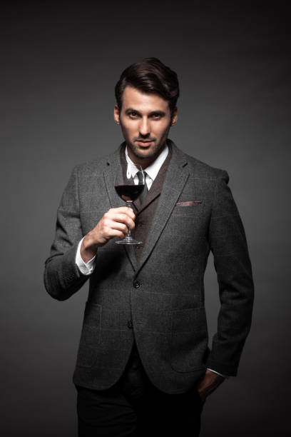 istock Handsome young man with a glass of wine 876378824