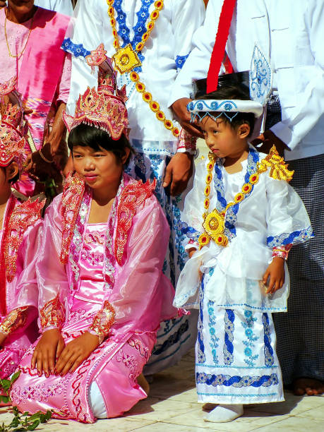 Local people in traditional costumes taking part in wedding ceremony at Mahamuni Pagoda, Mandalay, Myanmar. Mahamuni Pagoda is a Buddhist temple and major pilgrimage site in Myanmar.