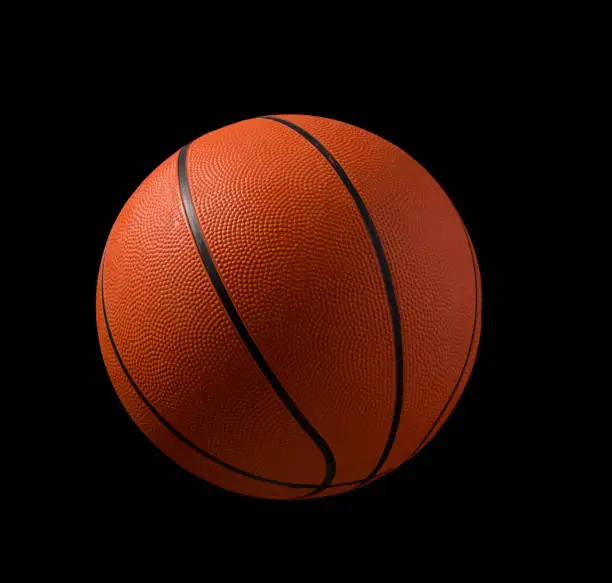 A orange basketball isolated on a black background with clipping path and copy space for text.