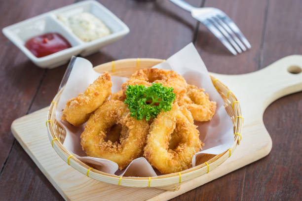 istock Fried calamari rings in wicker basket and sauce 876388148