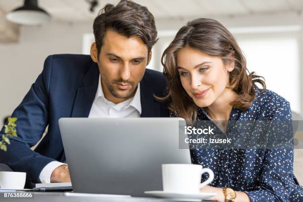 Couple Of Business People Working On Laptop At Cafe Stock Photo - Download Image Now