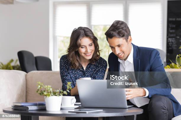 Modern Business People Working At A Cafe Stock Photo - Download Image Now - Laptop, Couple - Relationship, Financial Advisor