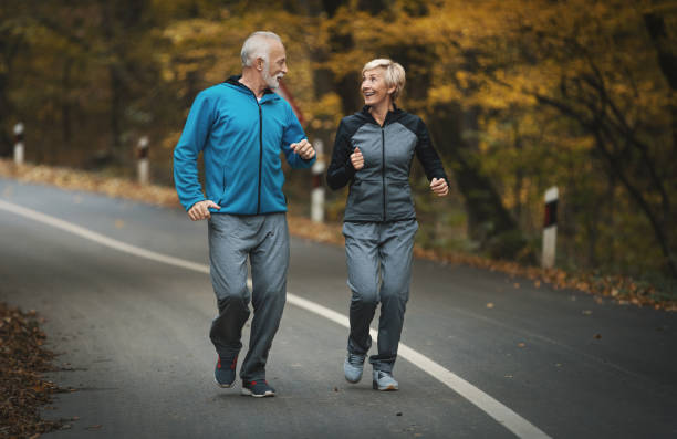 istock Senior couple jogging in a forest. 876403118