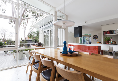 Scandinavian styled dining room and open plan kitchen with patio outlook