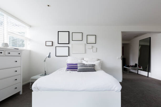 istock Bedroom with collection of blank frames on the wall for your art 876419974