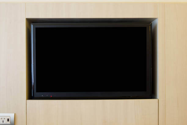istock Black LED television screen on wooden wall in room 876420488