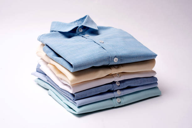 istock Classic men's shirts stacked on white background. 876424198