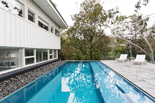 Infinity edge pool in backyard of mid century Australian luxury home