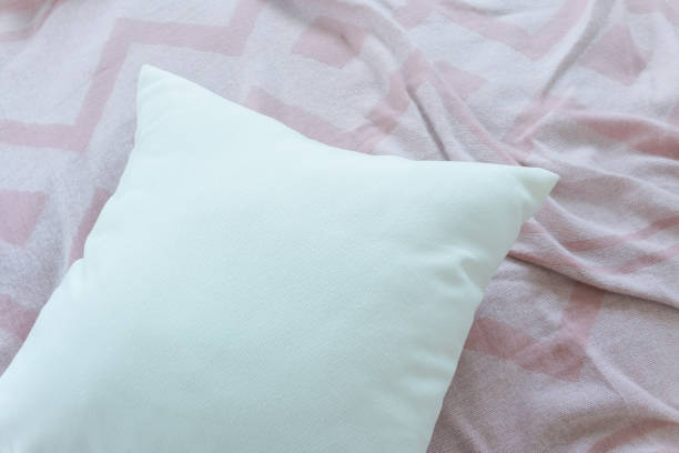 istock Close up white pillow on messy pink fabric background 876427912