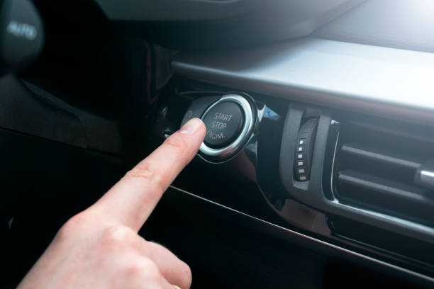 istock Finger press button functions car engine start and stop in motor vehicle for pre start checklist concept. Modern car interior details. Soft lighting 876428234