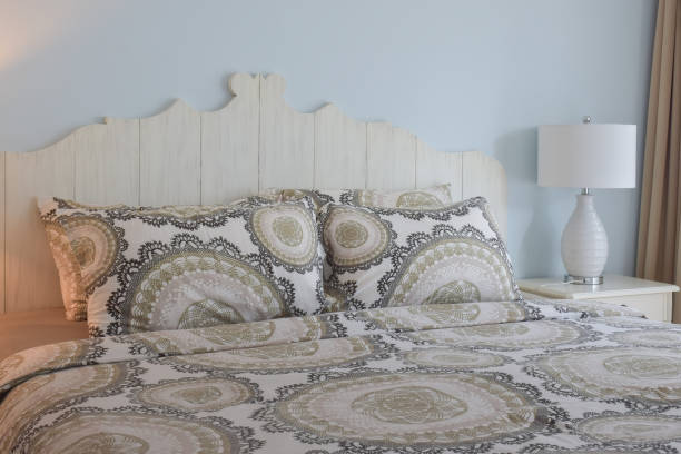 istock classic style bedding and reading lamp with blue wall 876428328