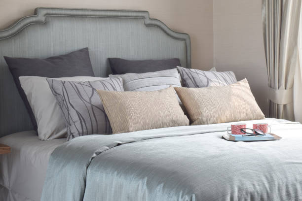 istock Mugs and book are on the romantic bedding style 876428354