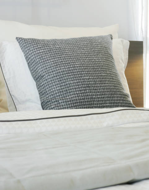 istock Closeup gray pillow on comfortable bed at home 876428692