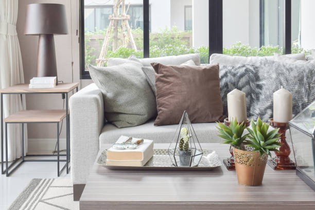 istock Brown and texture pillows on beige sofa with candles on wooden top table 876428802