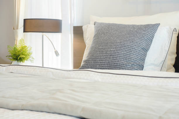 istock Closeup gray pillow on bed with modern classic style bedding 876428844
