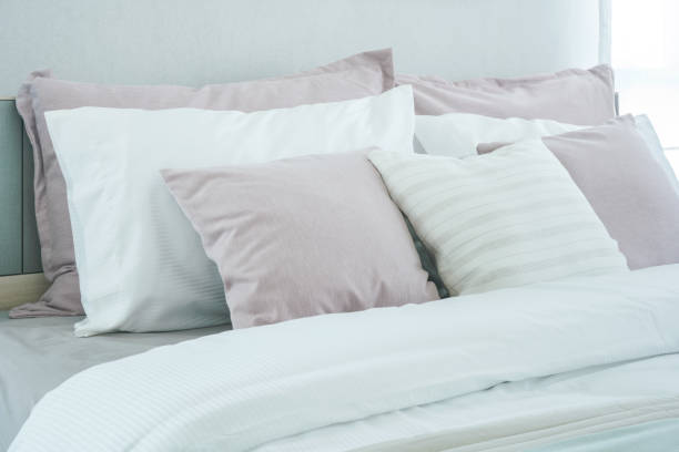 istock Pink pillows on bed in modern bedroom interior 876428870