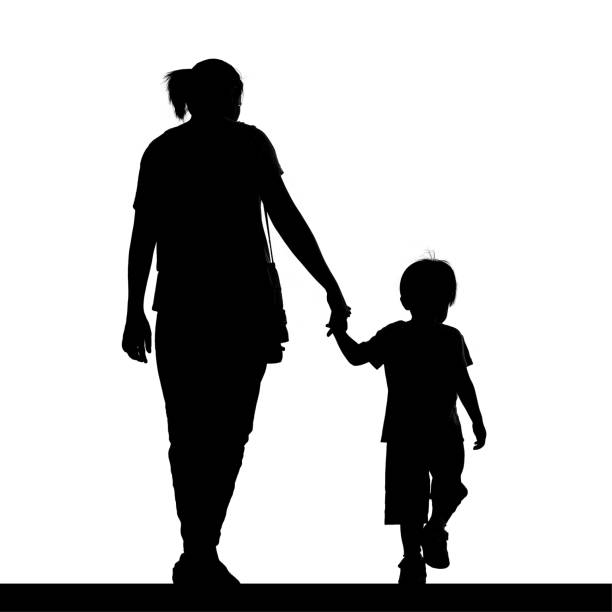 Silhouette of a mother holding her son isolated on white background stock photo