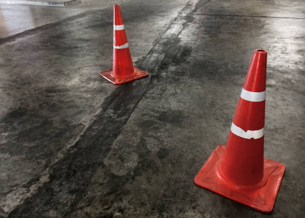 istock Orange Road Cones with White Stripes on the Floor 876441866