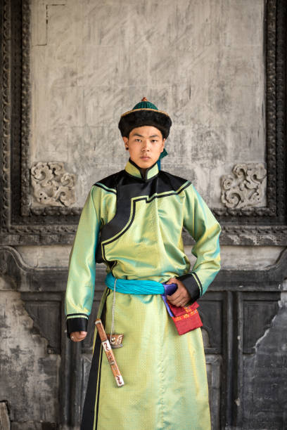 Young man in a traditional Mongolian outfit.