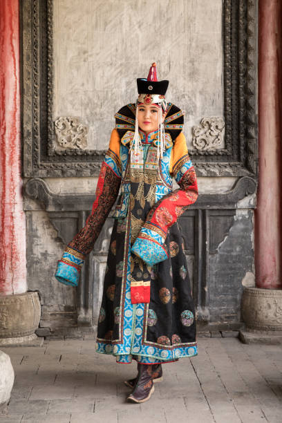 istock Young woman in a traditional Mongolian outfit. 876442652