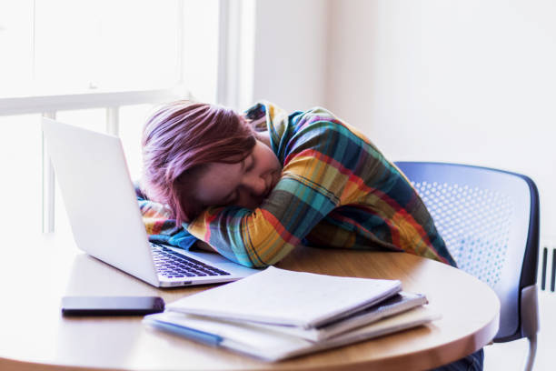 istock Exhausted college girl taking a short nap after her studies. 876445308