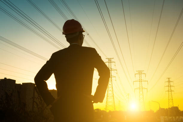 Electrical engineer at sunset,Back Lit Electrical engineer at sunset,Back Lit electricity substation photos stock pictures, royalty-free photos & images