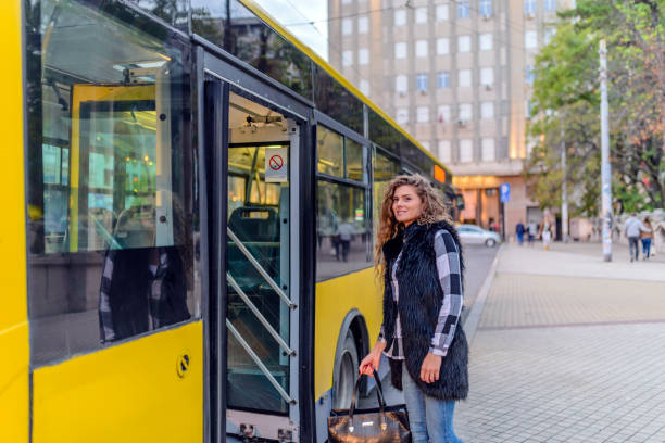 istock Young woman enters bus 876452436
