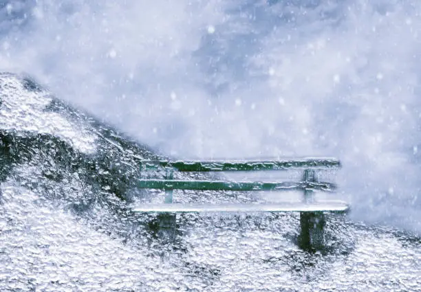 Wooden bench in winter storm