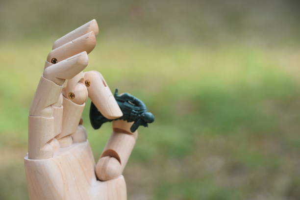 istock prosthetic hand holds  A toy soldier 876456228