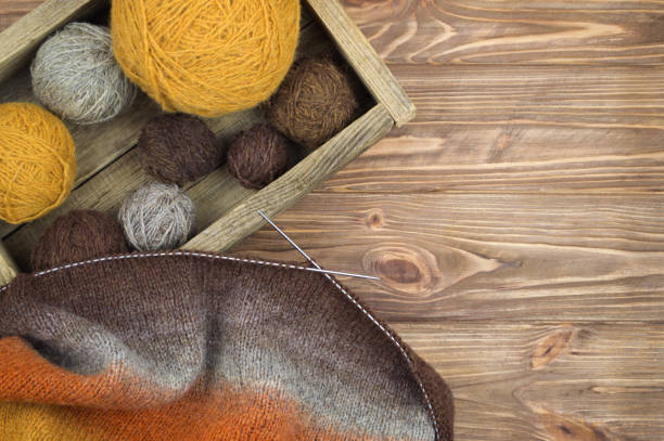 istock knitting needles and knitting on wooden background 876456322