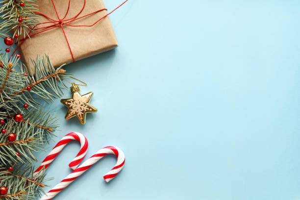 istock Christmas background. Christmas gift, fir tree, candy canes and decorations 876456376