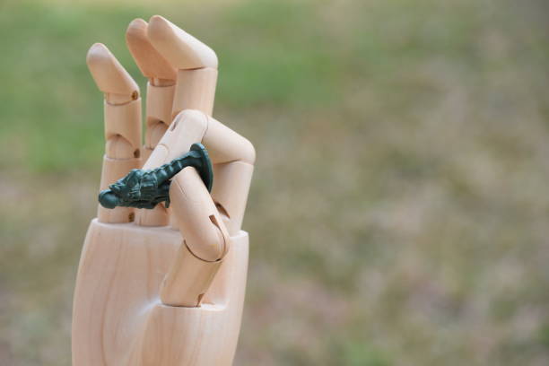 istock prosthetic hand holds  A toy soldier 876456466