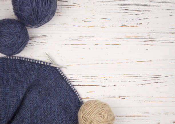 istock ball of wool with knitting needles and knitting 876456576