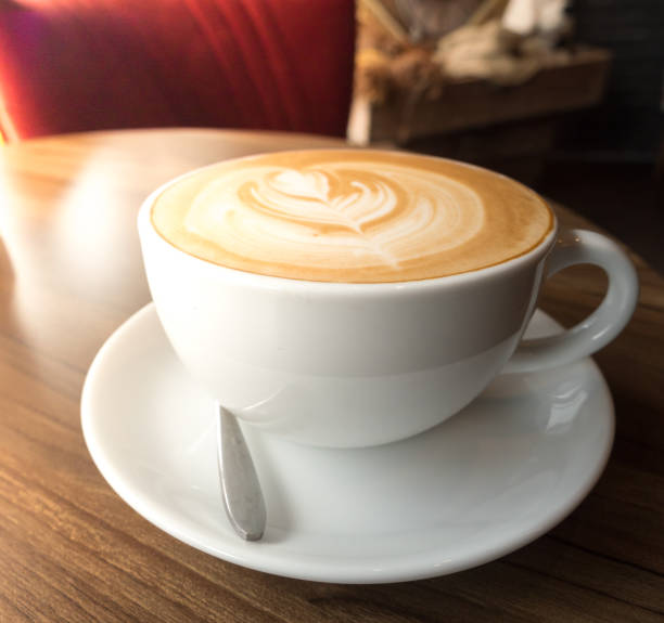 istock hot coffee in white cup on wood desk 876460162