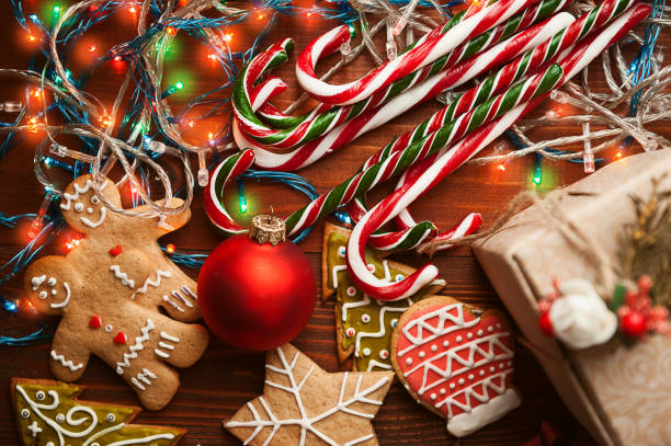 istock Christmas still life. homemade ginger biscuits, cane candy, on a wooden background. 876460764