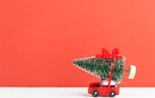 istock a toy car carries a Christmas tree 876463258