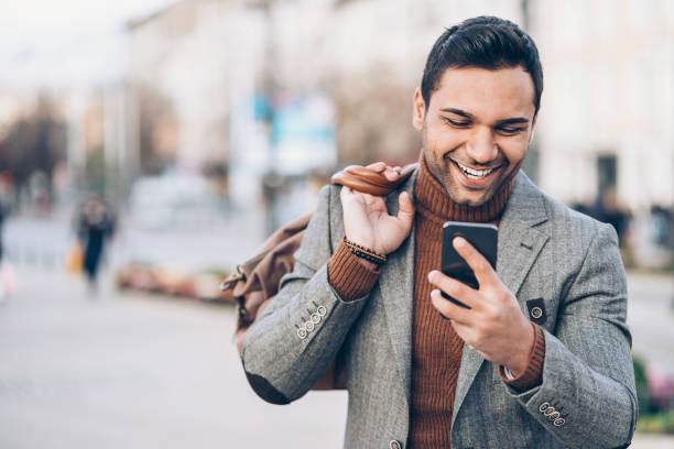 istock Man with bag and smart phone 876466384